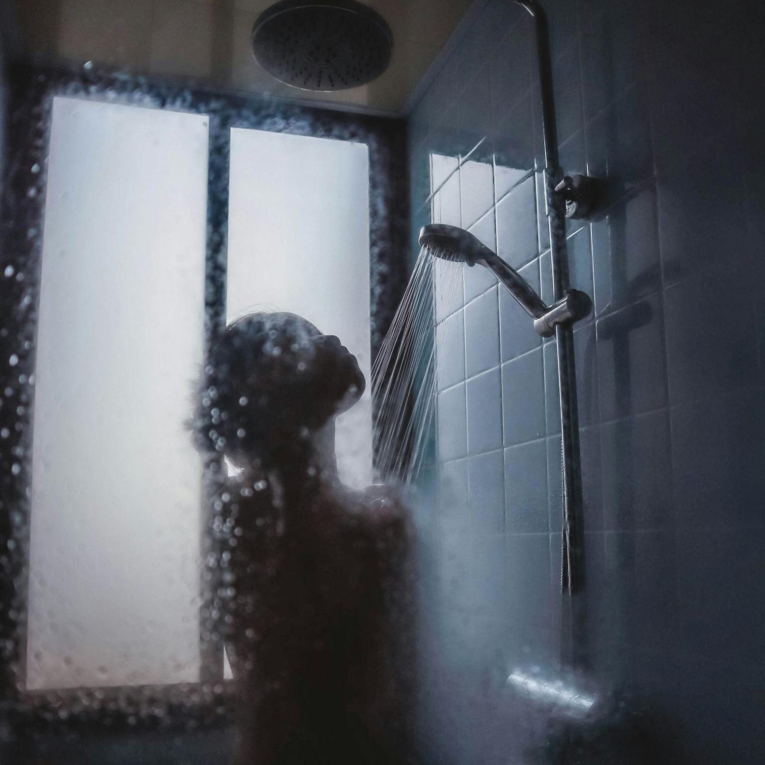 woman under showerhead