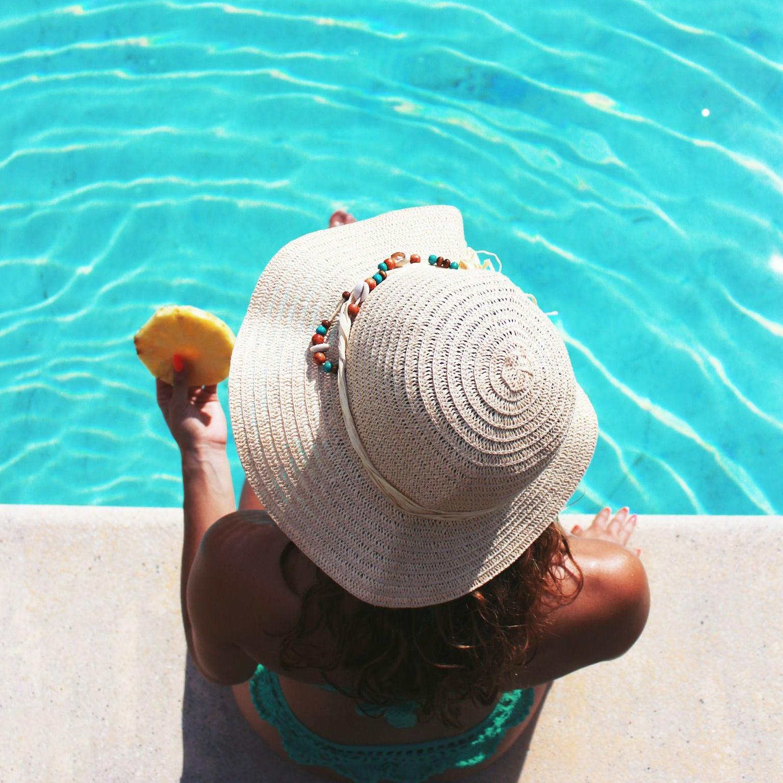 Piscine woman sitting beside swimming pool