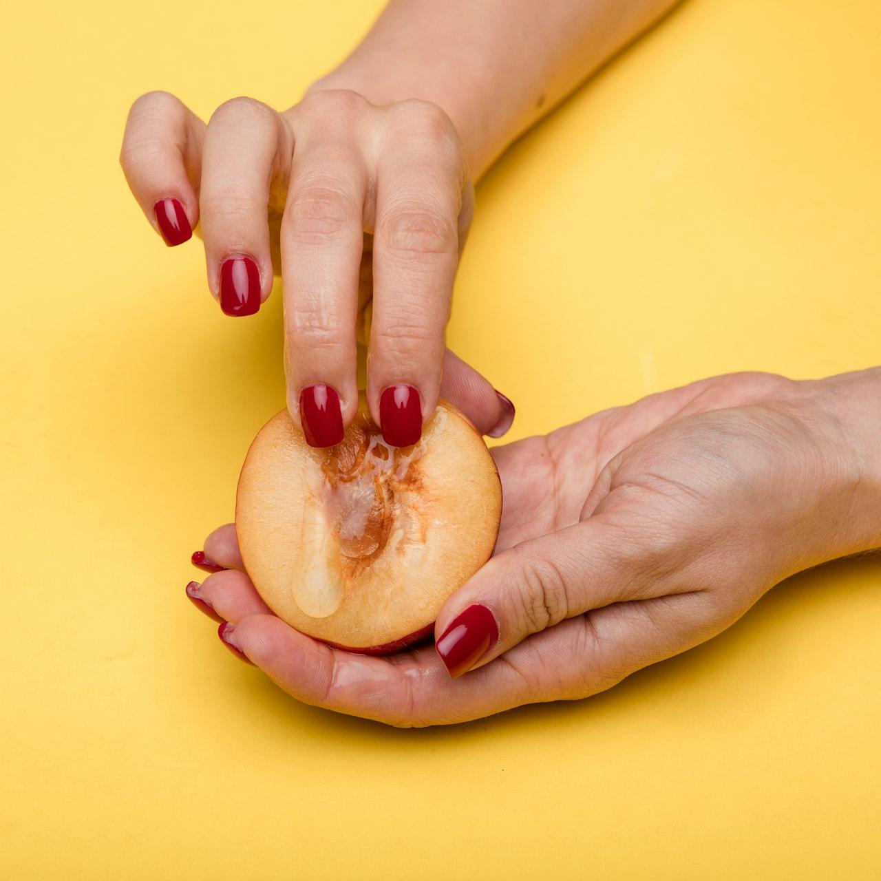 person holding a sliced of apple